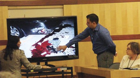 Vinicio Jimenez identifies possessions of his wife’s in a photo during Sudac’s trial.