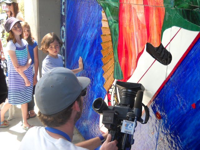 Photographer and kids at Surfing Madonna mosaic.