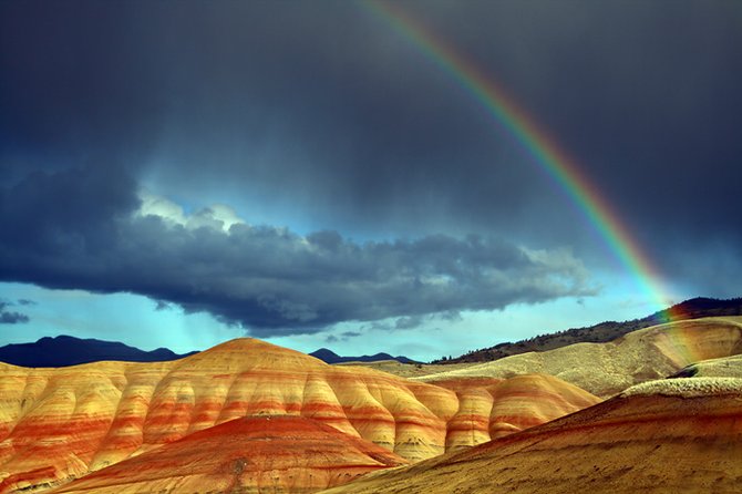 My wife and I were visiting the Painted Hills in eastern Oregon last month when we were caught in a severe storm. The wind was howling and the rain pouring down in buckets. All of the other visitors had packed up and gone home. Just as we were getting ready to follow them on out, the clouds lifted, the rain abated and we were treated to the most magnificent rainbow we had ever seen.
