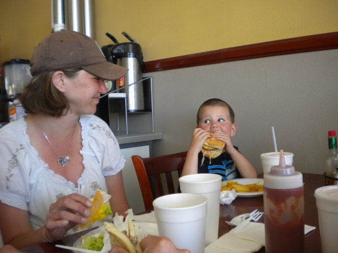 Three-year-old Kole from Denver, Colorado, looks to his mom, Beckie, for back-up in his attack on a quarter-pounder.