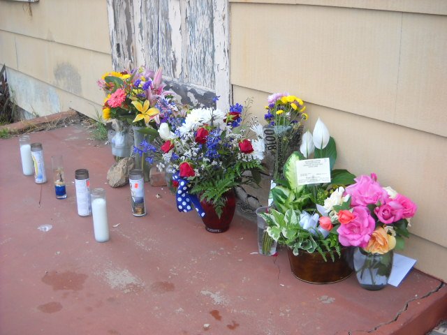 Floral tributes accumulate at crash victim Jim Cummins front door.