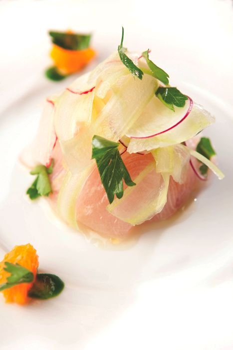 Seared and chilled yellowtail served with tangerine ice and purée with a parsley purée and leaf, finished with a salad of shaved radish and celery