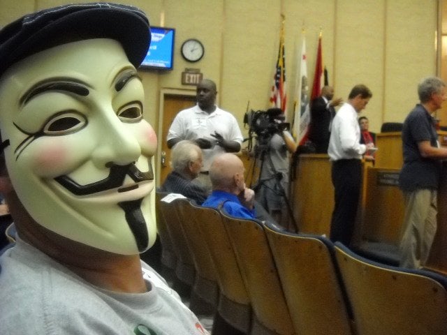 Masked observer at City Council meeting discussing medical marijuana ordinances.