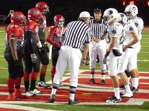 Helix and Mount Miguel team captains meet at midfield for the coin toss