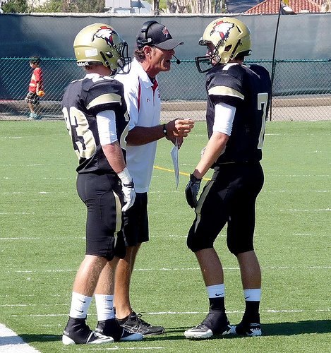 Santa Fe Christian coach Nick Ruscetta gives instruction to Eagles receiver Jacob McKinney (7)