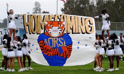 Morse cheerleaders hold up the Homecoming banner during halftime