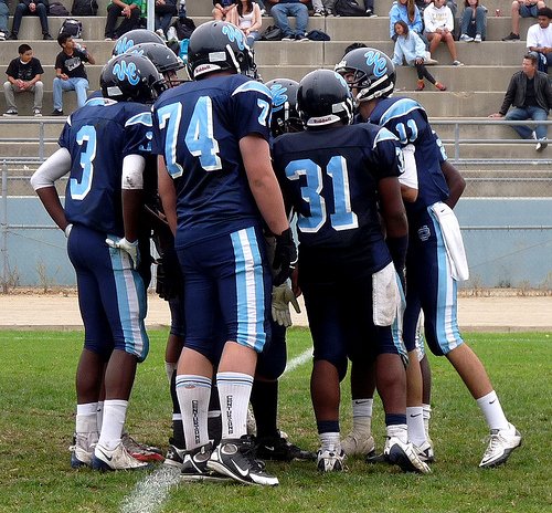 University City quarterback Logan Stewart calls out the play in the offensive huddle