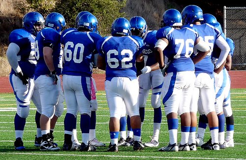 San Diego quarterback Khari Kimbrough calls out the play in the Cavers huddle