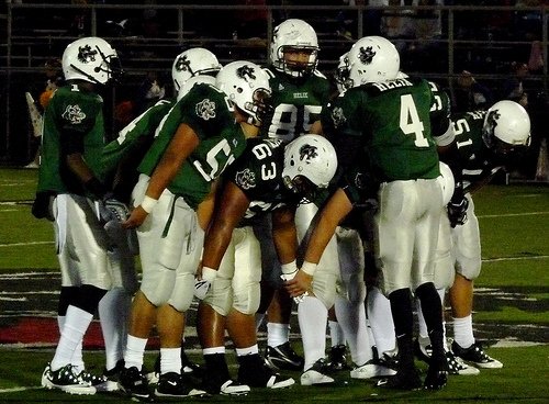 Helix quarterback Brandon Lewis calls out the play in the offensive huddle