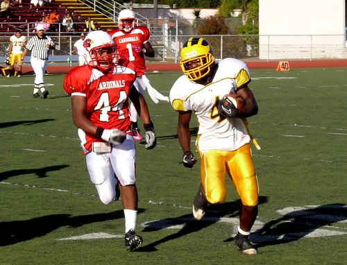 Mission Bay running back Chris Byrd sprints downfield with Hoover linebacker Corey Mims chasing him down