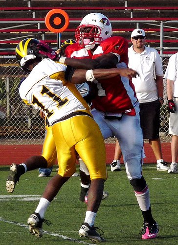 Mission Bay quarterback Nate Long takes a hit from Hoover defensive end Dame Ndiaye after throwing the ball