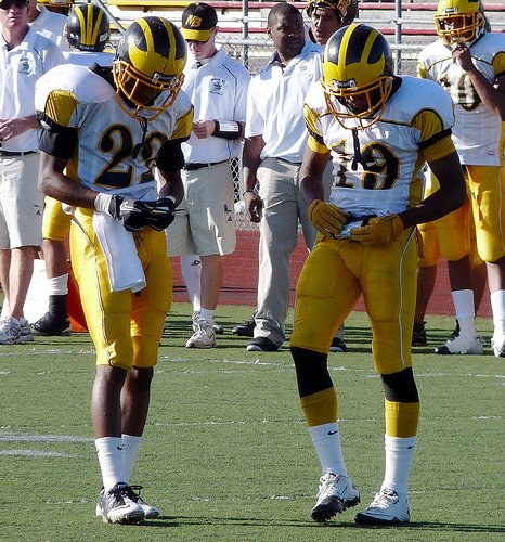 Mission Bay receivers Anthony Magee (22) and Jaquan Maydun (19) each check their play card at the line of scrimmage