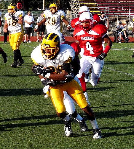 Mission Bay running back Ilan Martinez carries a Hoover defender on his back