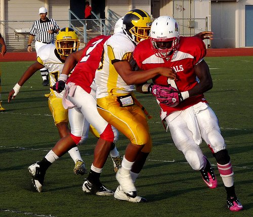 Hoover receiver Dame Ndiaye fights through a Mission Bay tackler