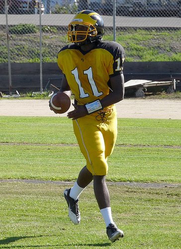 Mission Bay quarterback Nate Long jogs off the field after scoring a touchdown