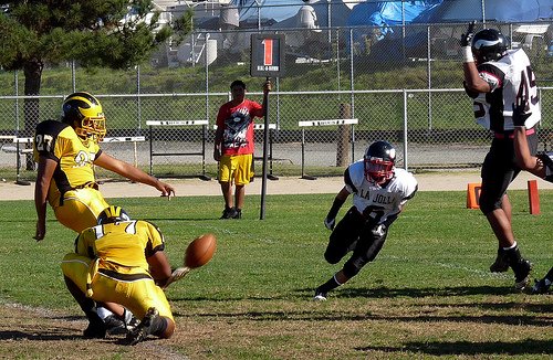 A pair of La Jolla defenders tries to block an extra point by Mission Bay kicker Jorge Duarte