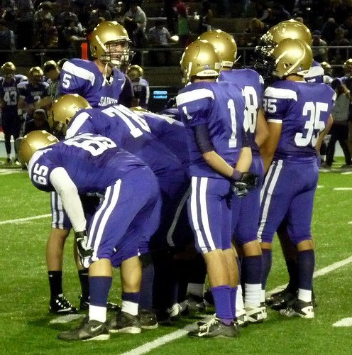 St. Augustine quarterback Evan Crower calls out the play in the offensive huddle