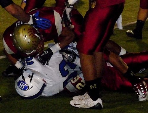 Mission Hills defensive back Rolundo Cotto finishes the tackle of Rancho Bernardo running back David Jones