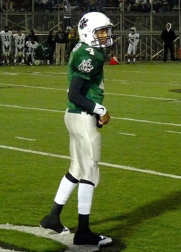 Helix quarterback Brandon Lewis checks the sideline for the play call