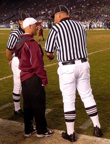 Mission Hills head coach Chris Hauser has a word with the officials
