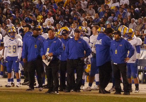 Mira Mesa head coach Gary Blevins, notebook in hand, looks on from the sideline