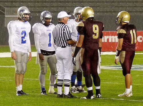 Brookside Christian and Bishop’s team captains meet at midfield at the start of the second half