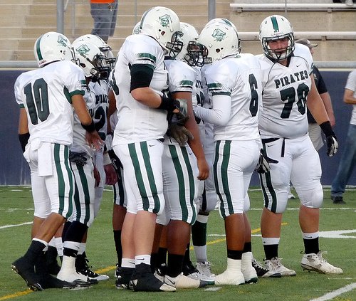 Oceanside quarterback Tofi Pao Pao calls out the play in the huddle