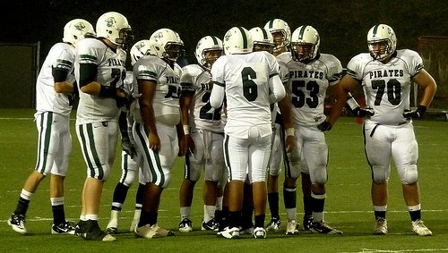 Oceanside quarterback Tofi Pao Pao calls out a play in the offensive huddle
