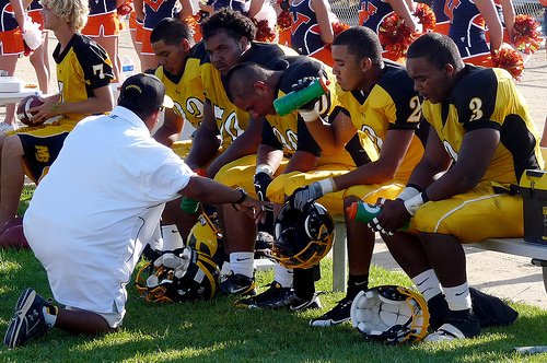 Mission Bay’s defensive coordinator talks to the Bucs defense on the sideline