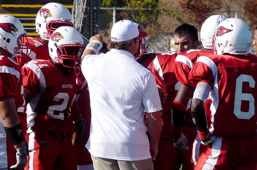 Hoover’s defensive coordinator talks to Cardinals players during a timeout