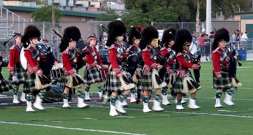 Helix band members walk off the field in traditional Scottish garb