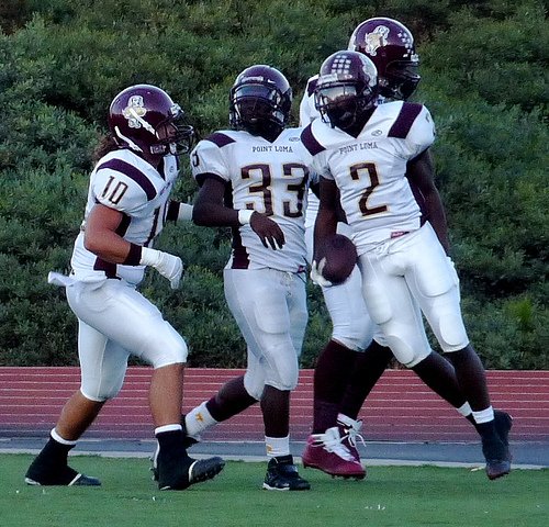 Point Loma defensive back Josh Sakover celebrates a pick six with his teammates