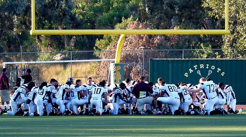 Point Loma players gather in the endzone before their game against Patrick Henry