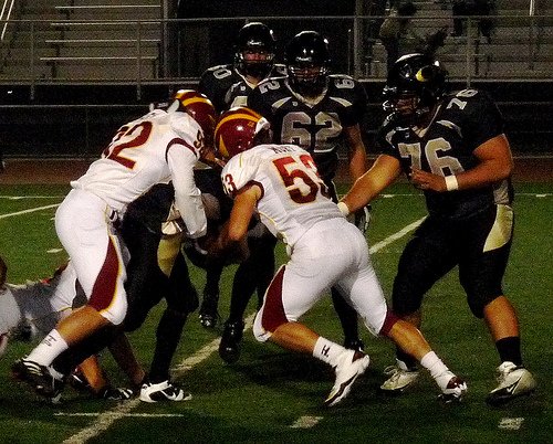 Torrey Pines linebackers Codi Jones (92) and Willie Mort wrap up Olympian quarterback Cobrin Humphery