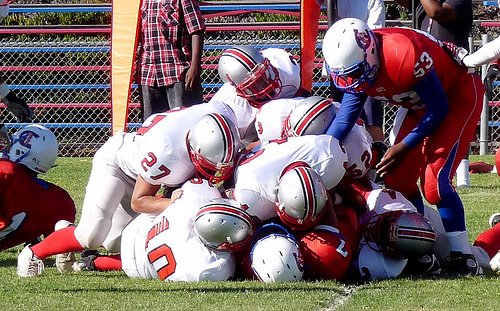 A host of Van Nuys defenders pile on Crawford quarterback Jorge Perez