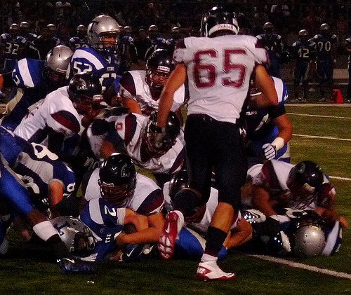 A host of Steele Canyon defenders pile on Eastlake running back Jude Isbell (2)