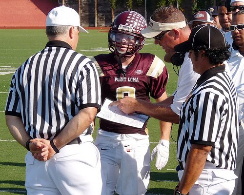 Point Loma quarterback Thomas Mize and head coach Mike Hastings object to a penalty call