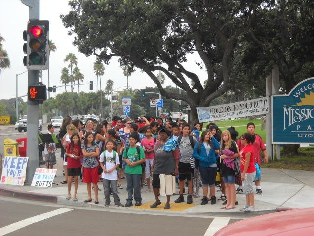 A gaggle of kids getting ready to cross Mission Blvd. and hit the beach.