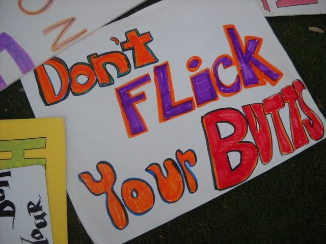 Colorful anti-litter sign at HOLD ON TO YOUR BUTT Mission Beach event.
