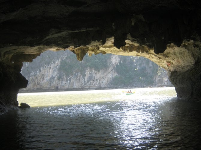 Kayaking into one of the exquisite grottos in Halong Bay, Vietnam.
