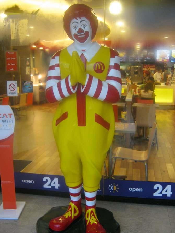 Ronald McDonald follows the local custom in Chiang Mai, Thailand.