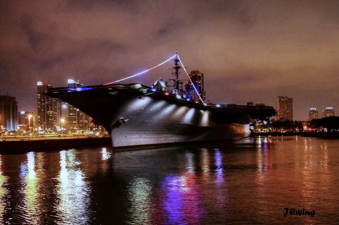 Aircraft carrier lit up at night.