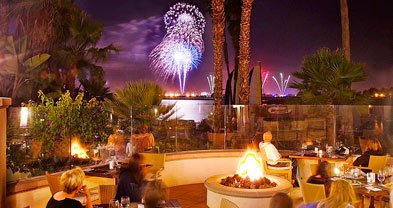 Diners on the terrace at the Mission Bay Hilton's Acqua enjoy a view of SeaWorld's fireworks.
