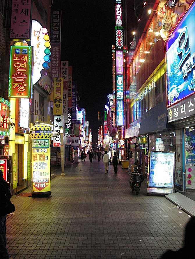 A neon-lit walkway in Busan