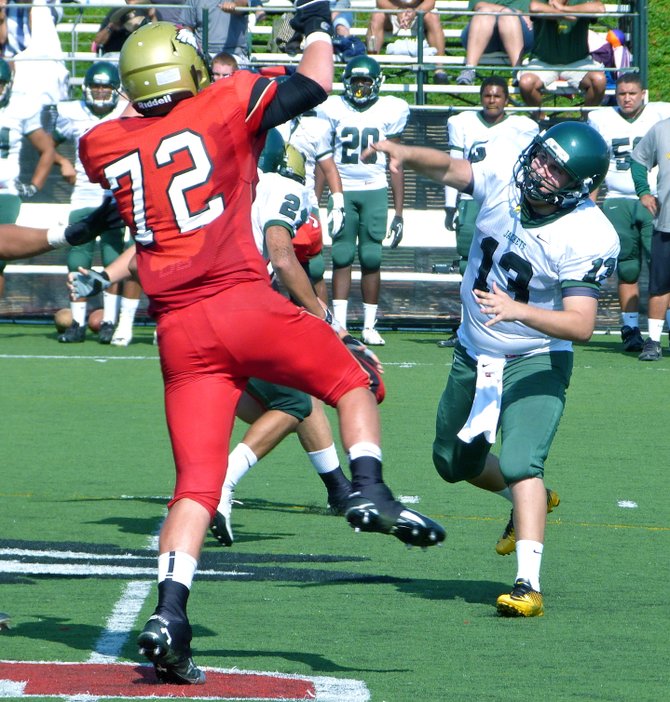 Palo Verde Valley quarterback Ryan Galvan fires a pass over outstretched Santa Fe Christian lineman Dominic Burtech