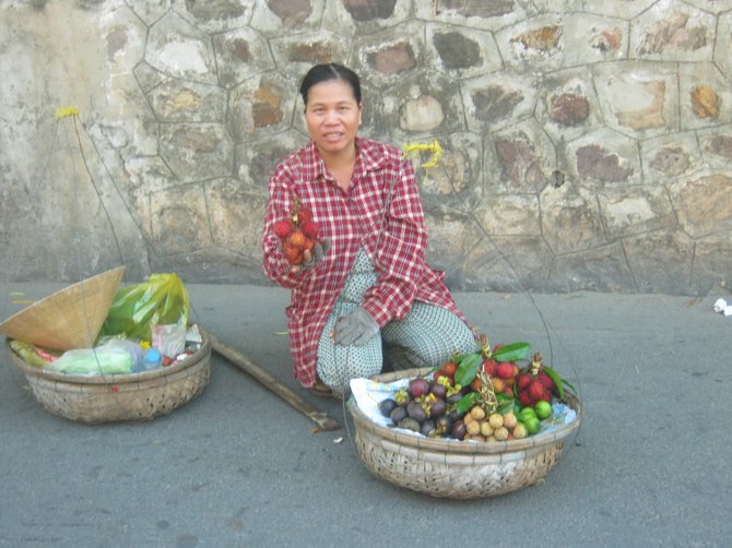 Fruit merchant in Hoi An, Vietnam. Yes, I tried them and they're delicious.