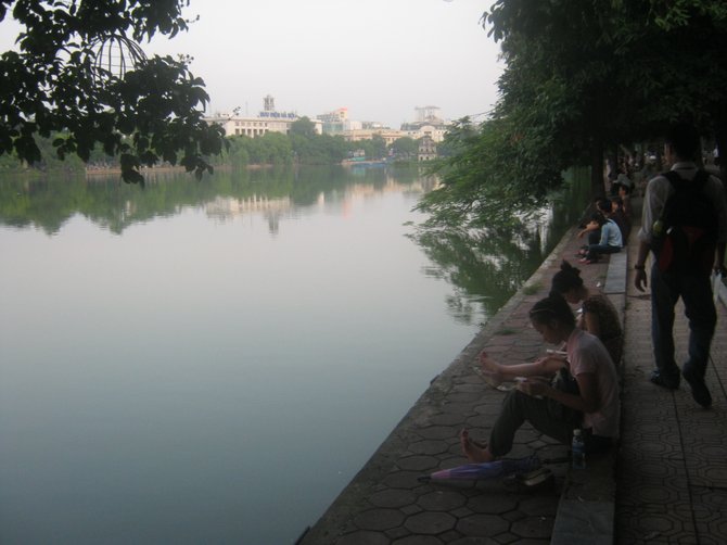 Vietnamese students relax along Hoan Kiem Lake in Hanoi.