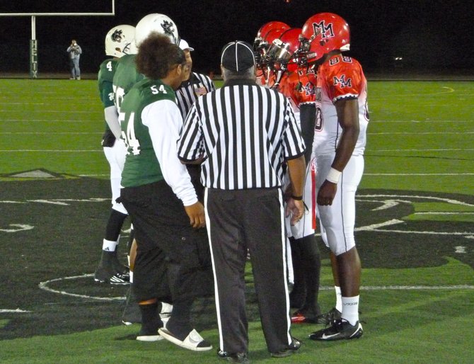Helix and Mount Miguel captains meet at midfield for the coin toss