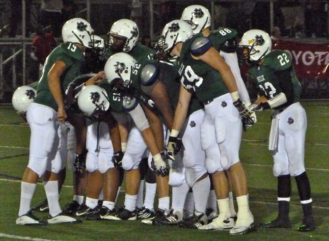 Helix quarterback Matt Anderson gives the play to the Highlander offense in the huddle