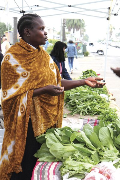 Uganda native Luchia Lokonyen sells spinach and collard greens each Saturday at the City Heights Farmers’ Market